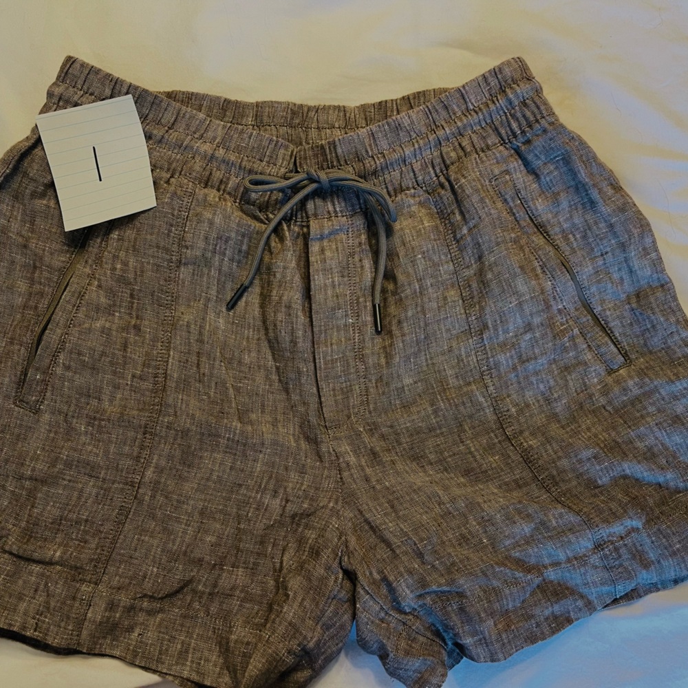 Athleta khaki linen shorts. Drawstring at the waist never been worn.